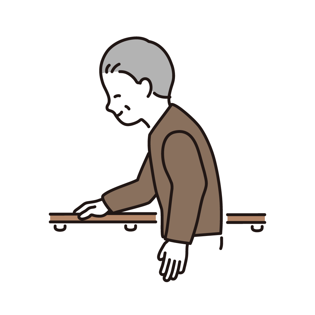 手すりに掴まって歩くシニア男性